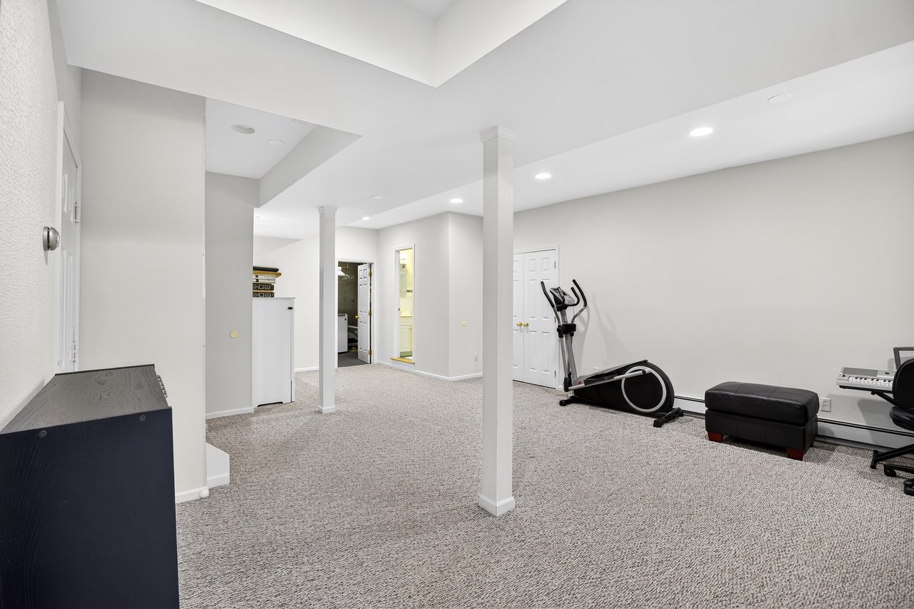 Alternate View of Recreation Room with custom closet storage, full bathroom, office and laundry.