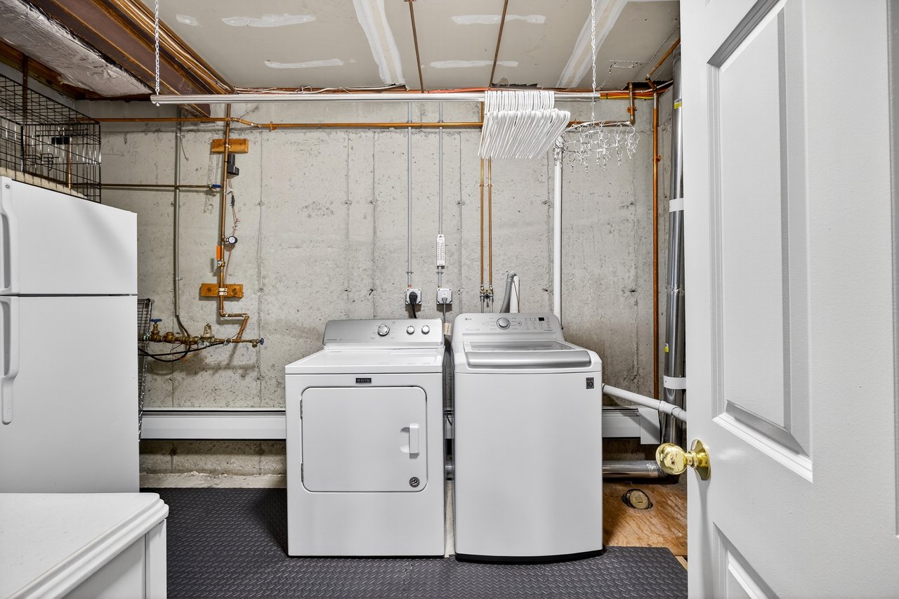 Laundry area featuring washer and dryer plus storage.