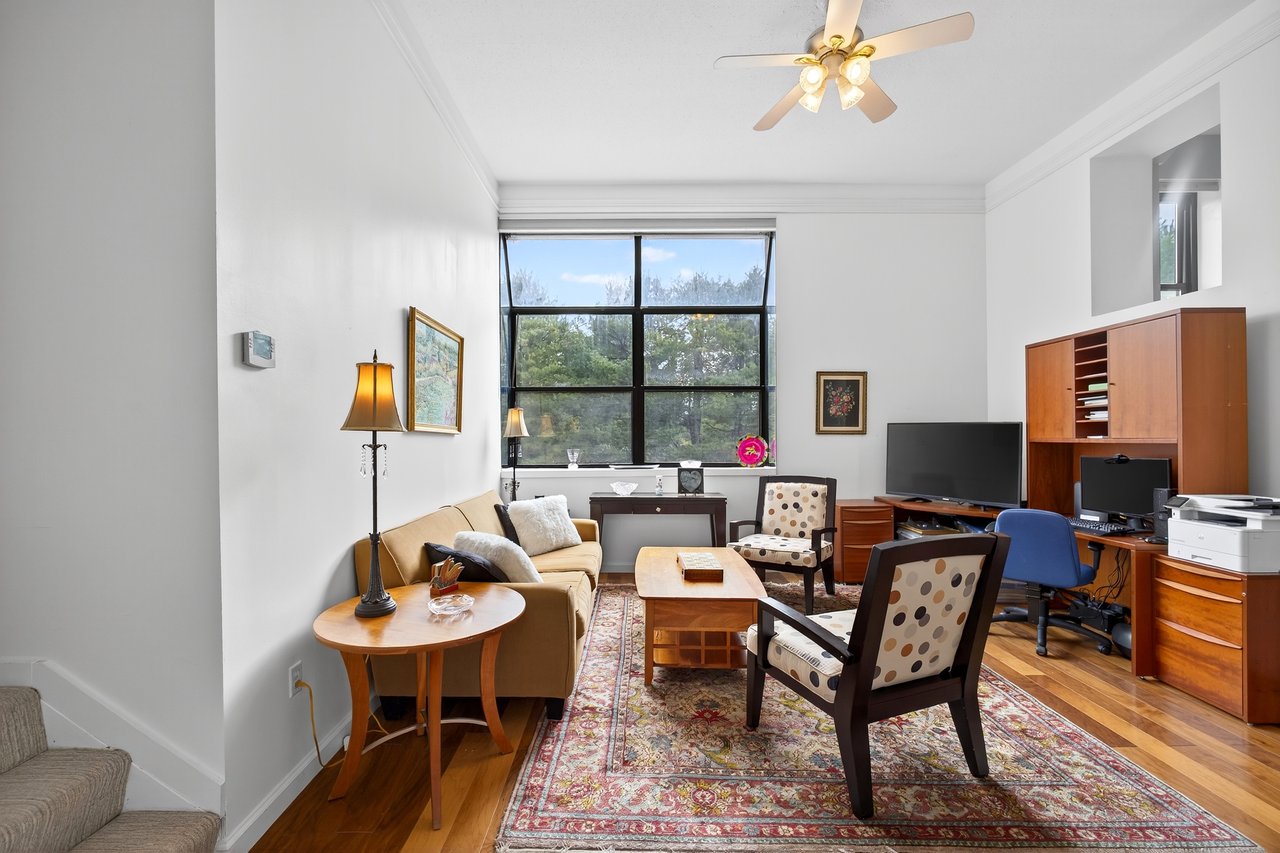 Office area with crown molding, wood finished floors, and ceiling fan...