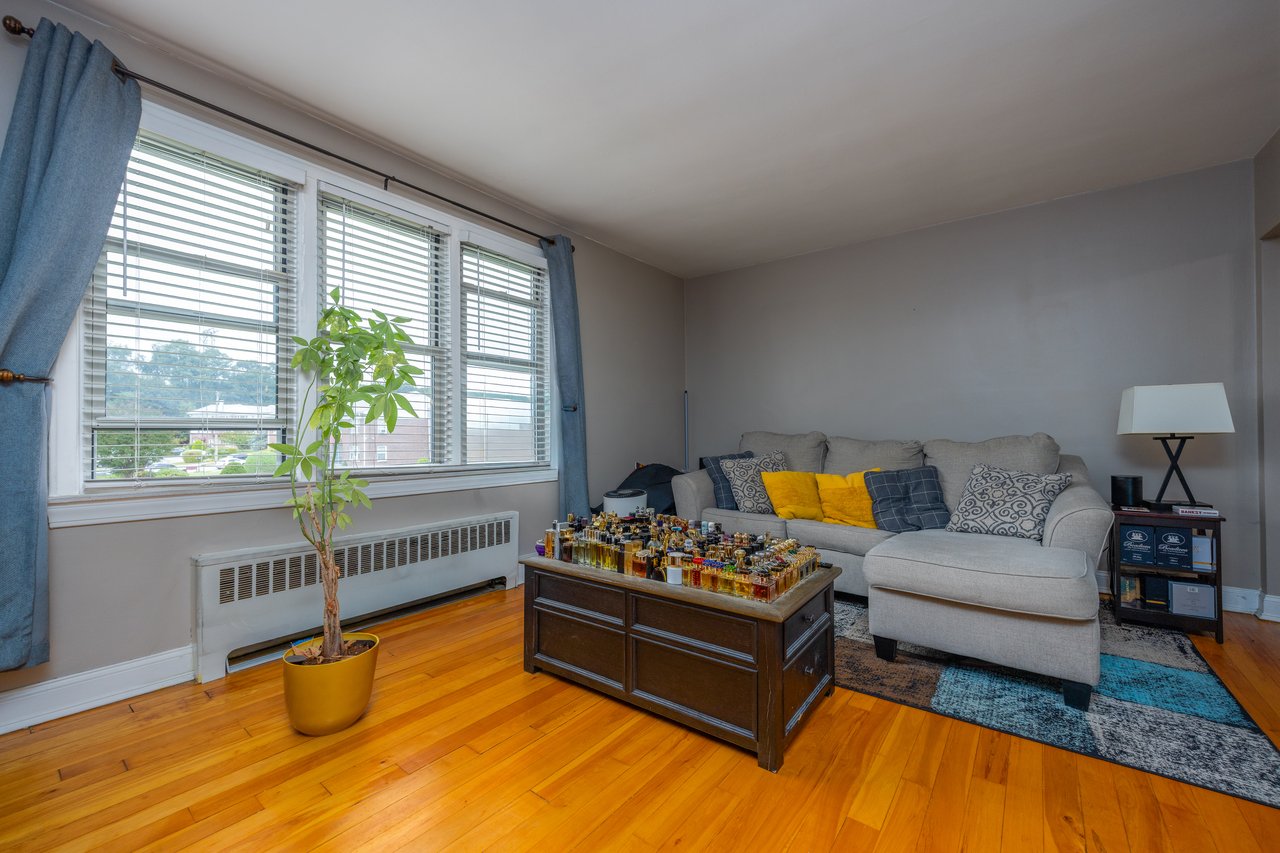 Living area featuring radiator and light wood-type flooring