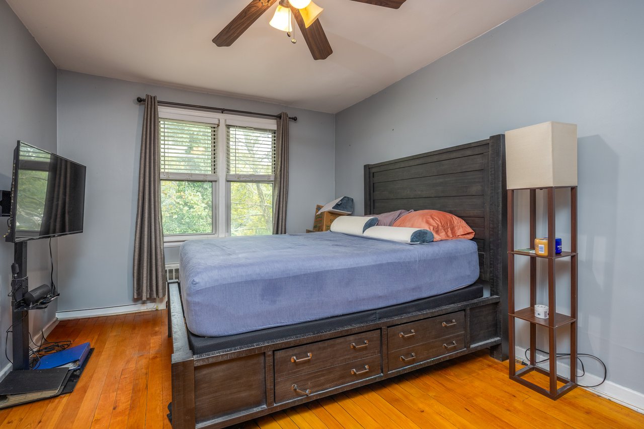 Bedroom with light wood-style flooring and ceiling fan