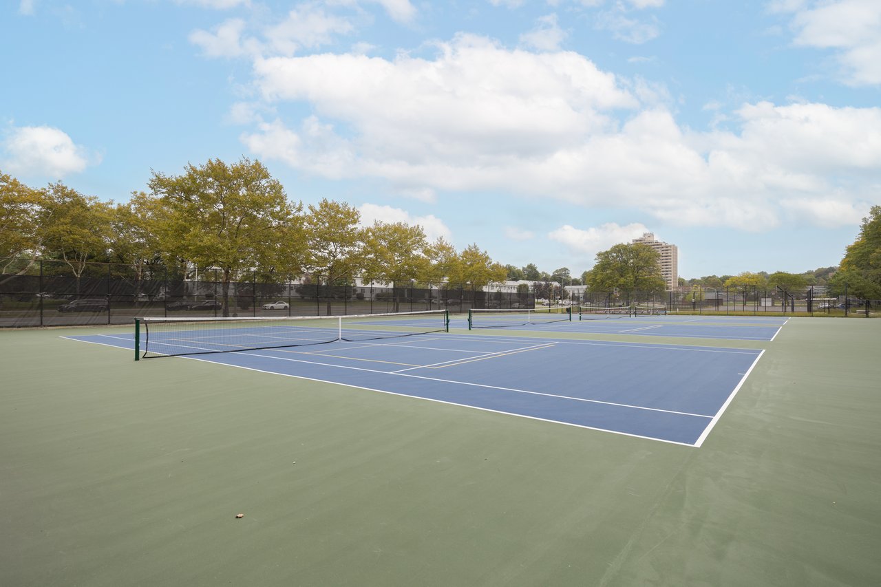 View of tennis court with community basketball court