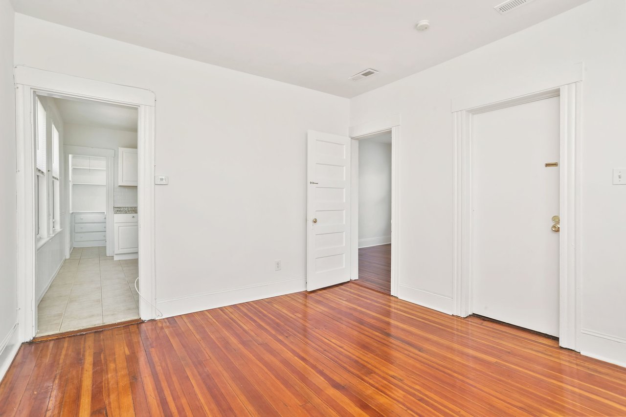Living room with view into kitchen