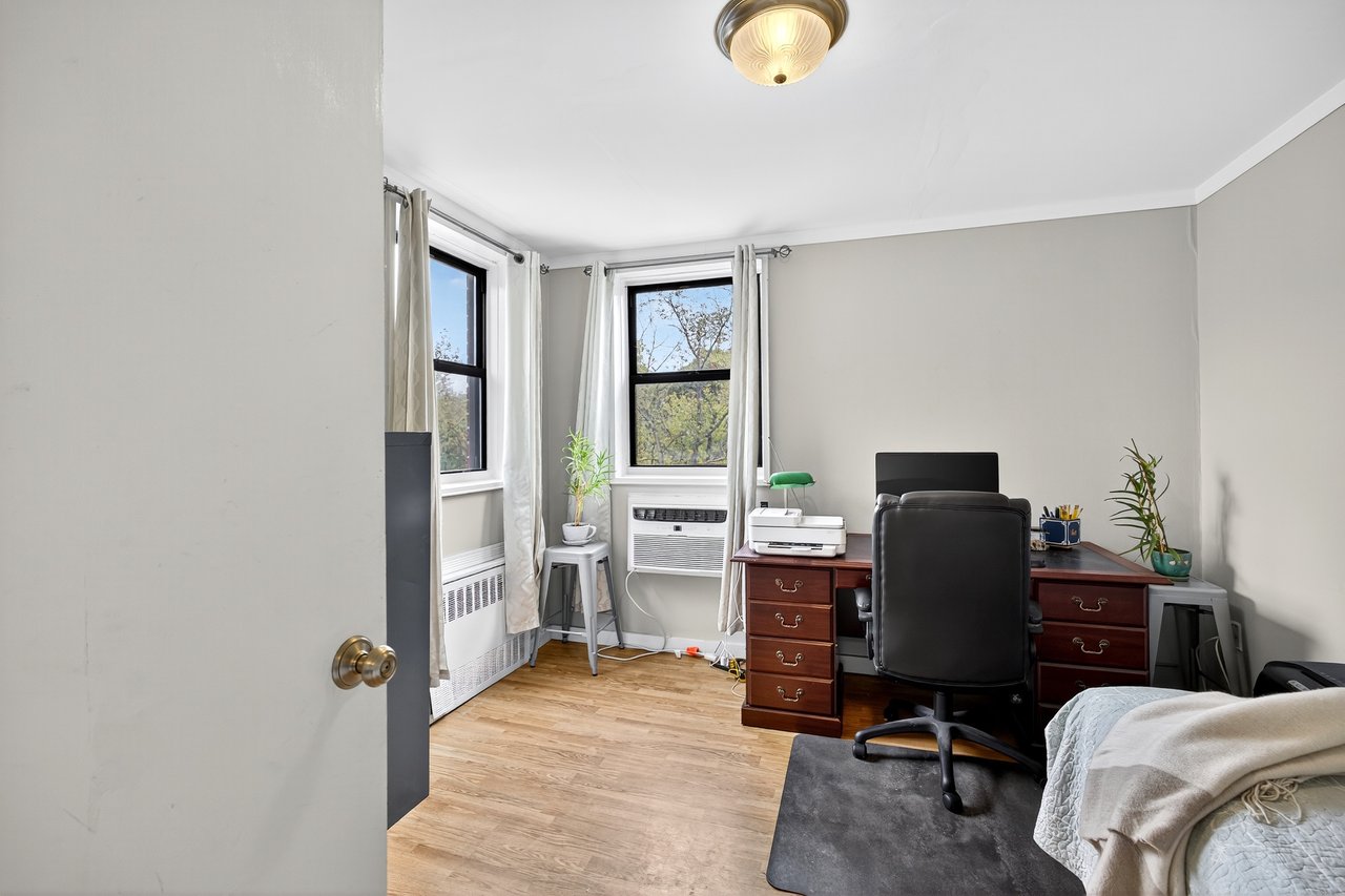 2nd Bedroom with light wood-style floors and radiator
