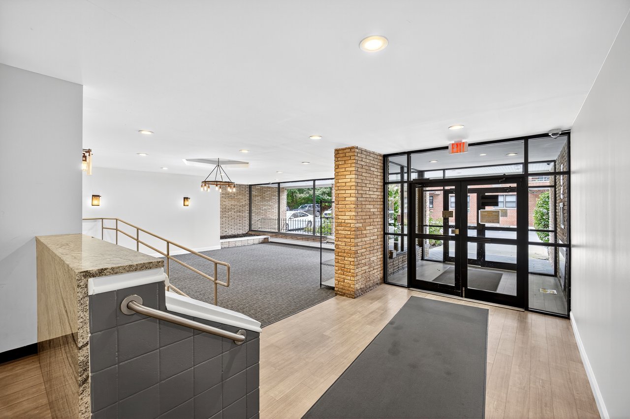 Building lobby featuring expansive windows and recessed lighting...