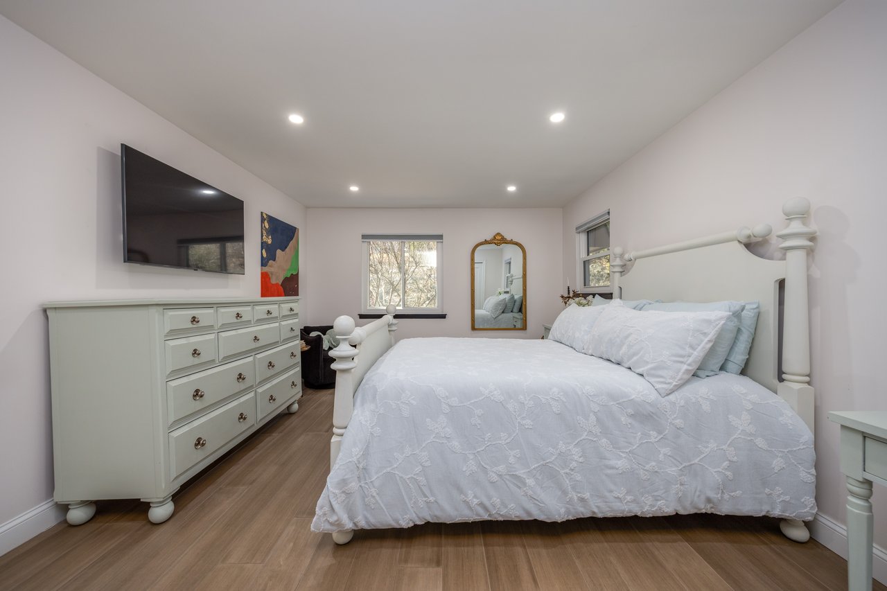 Bedroom featuring wood finished floors and recessed lighting...