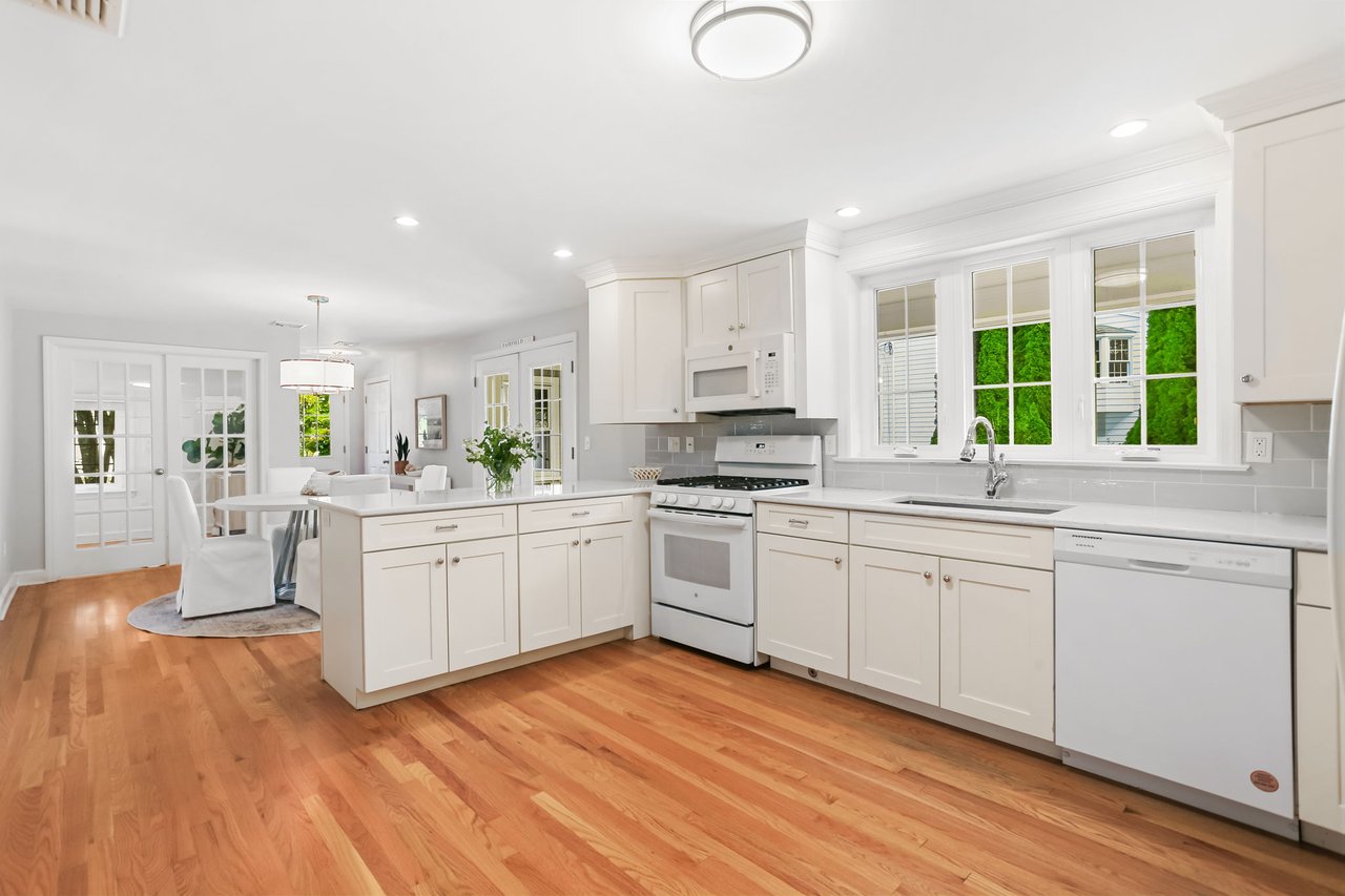 Spacious white kitchen with peninsula island.