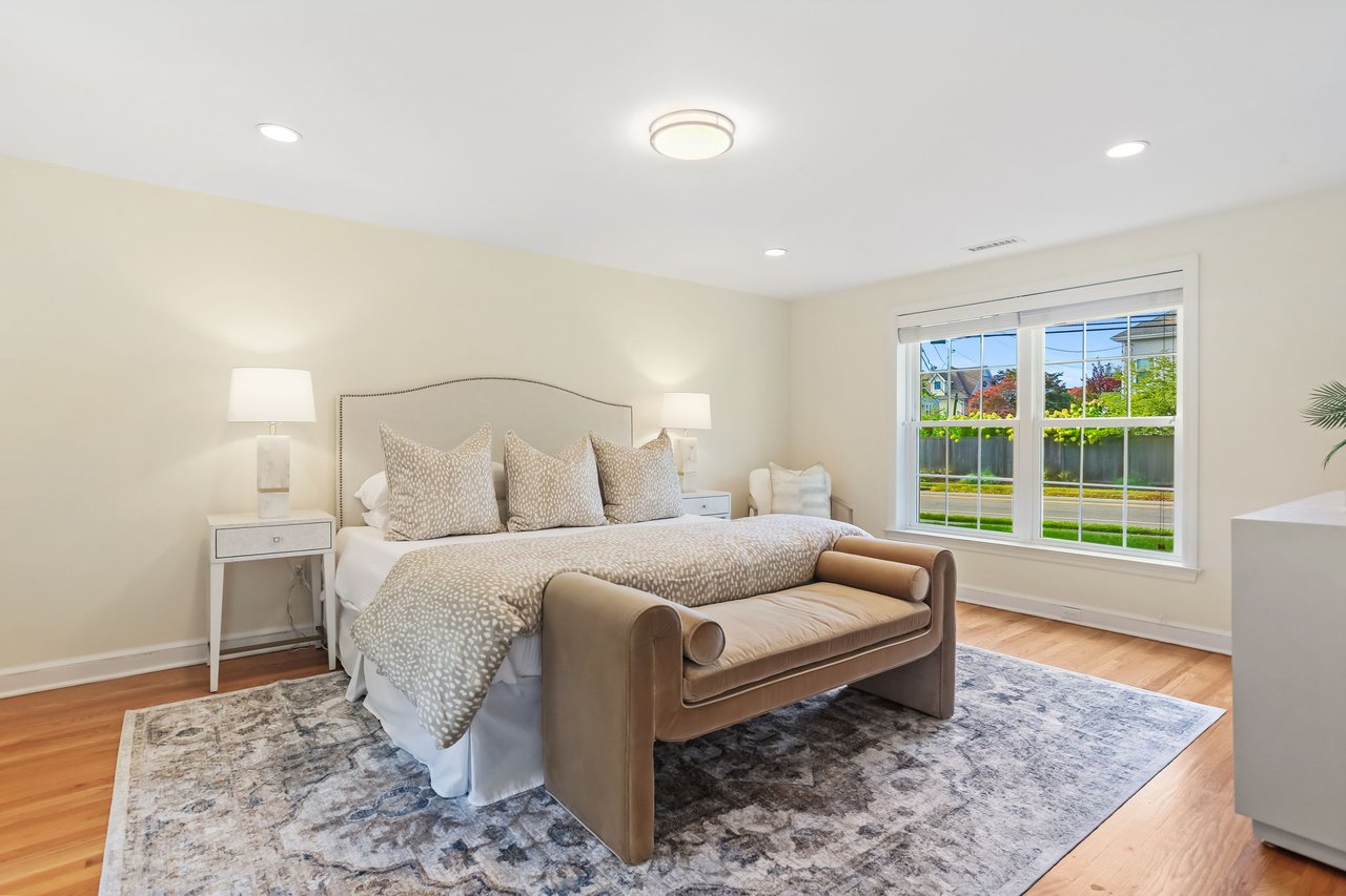 Main floor primary bedroom is spacious with two closets