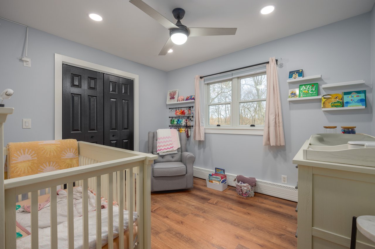 Bedroom featuring a closet, light wood-style flooring, a crib, ceiling fan, and recessed lighting