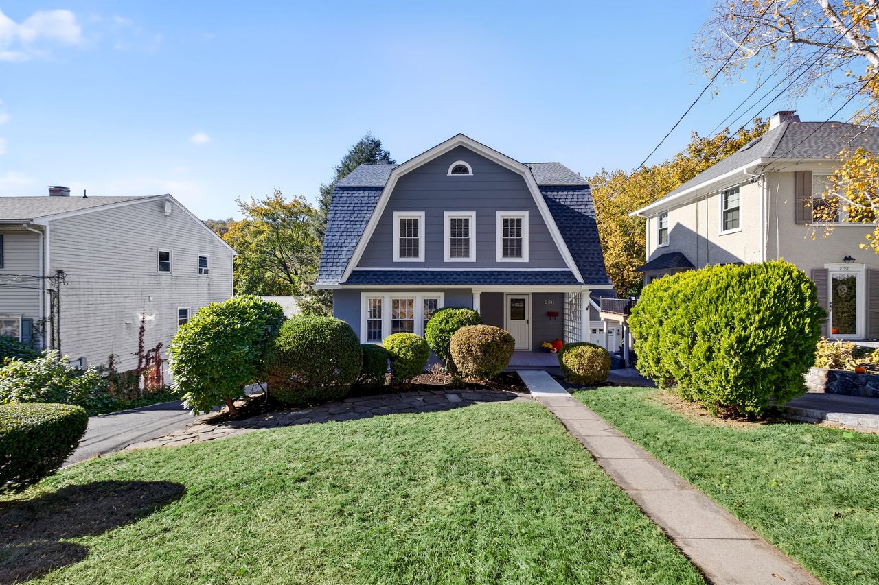 Welcome to 250 Washington Avenue, a Dutch colonial with a front yard and welcoming entry