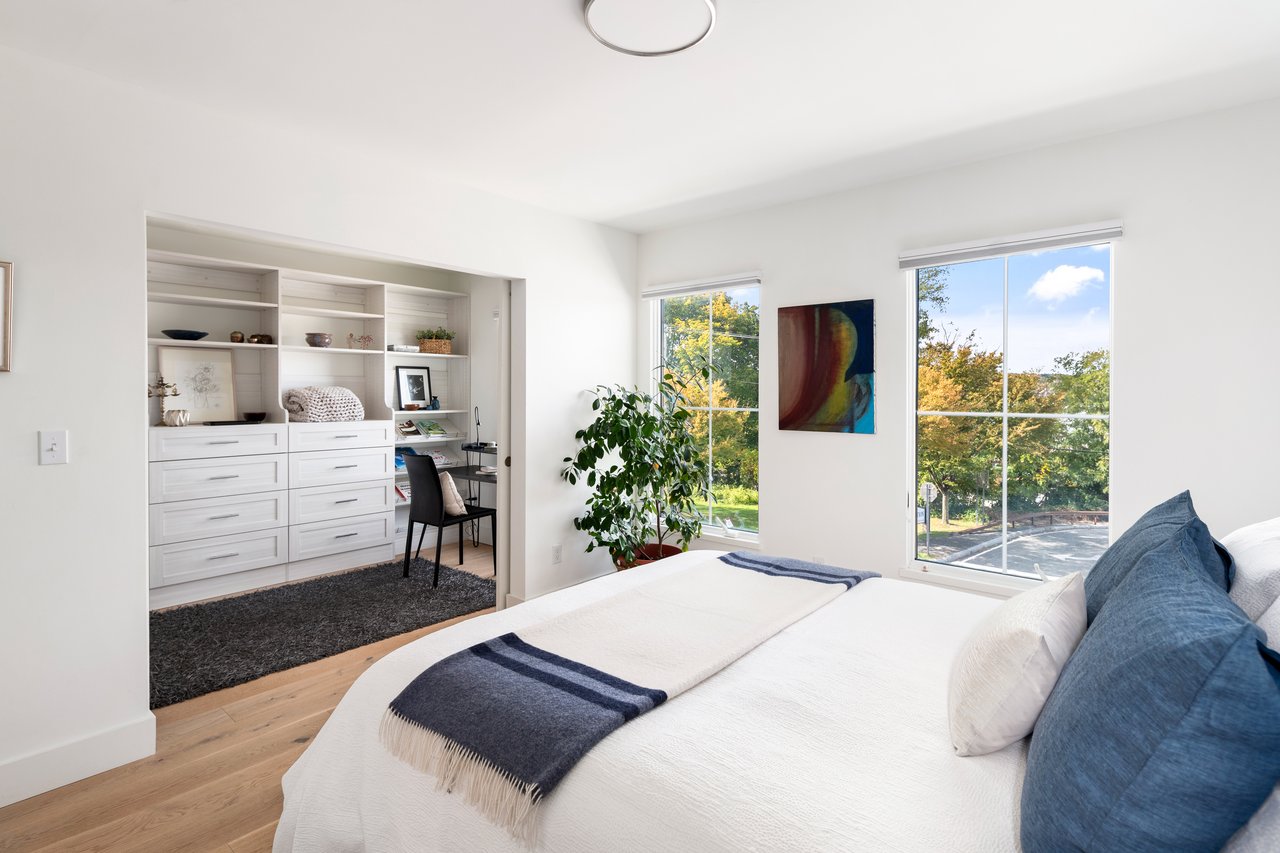 Primary bedroom suite with attached office/dressing room which can be made private by sliding barn doors..