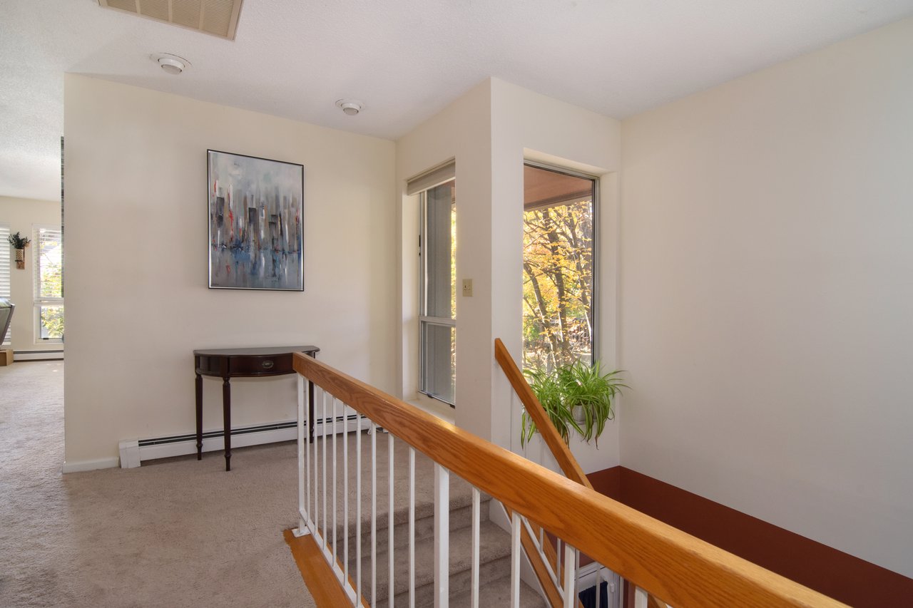 A short set of stairs — with a convenient midway landing for coats and shoes — leads you to the unit.