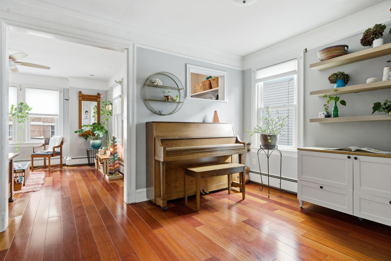 Sitting room featuring light wood-style floors and a baseboard radiator