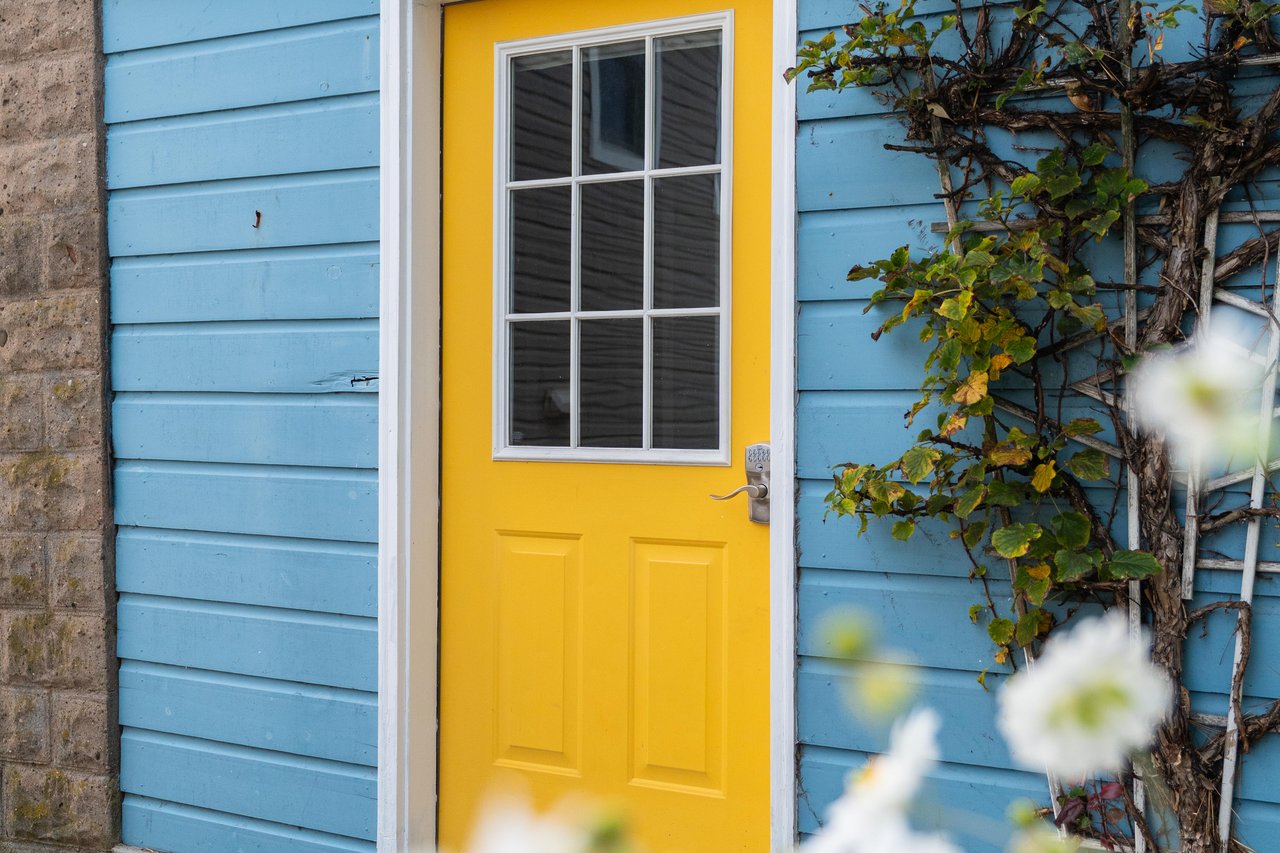 Home office featuring wood finished floors and lofted ceiling