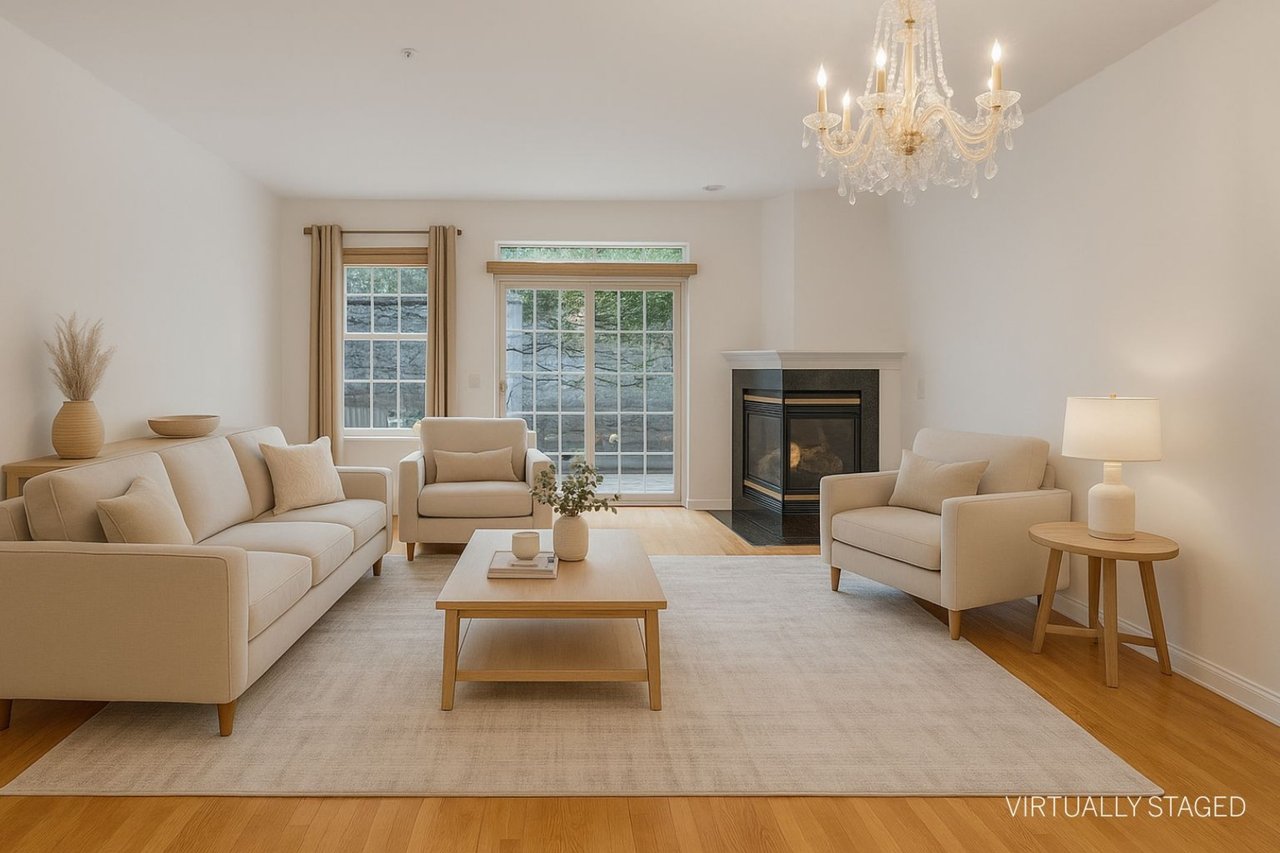 Virtually staged living area featuring light wood-style floors, a multi sided fireplace, and a chandelier