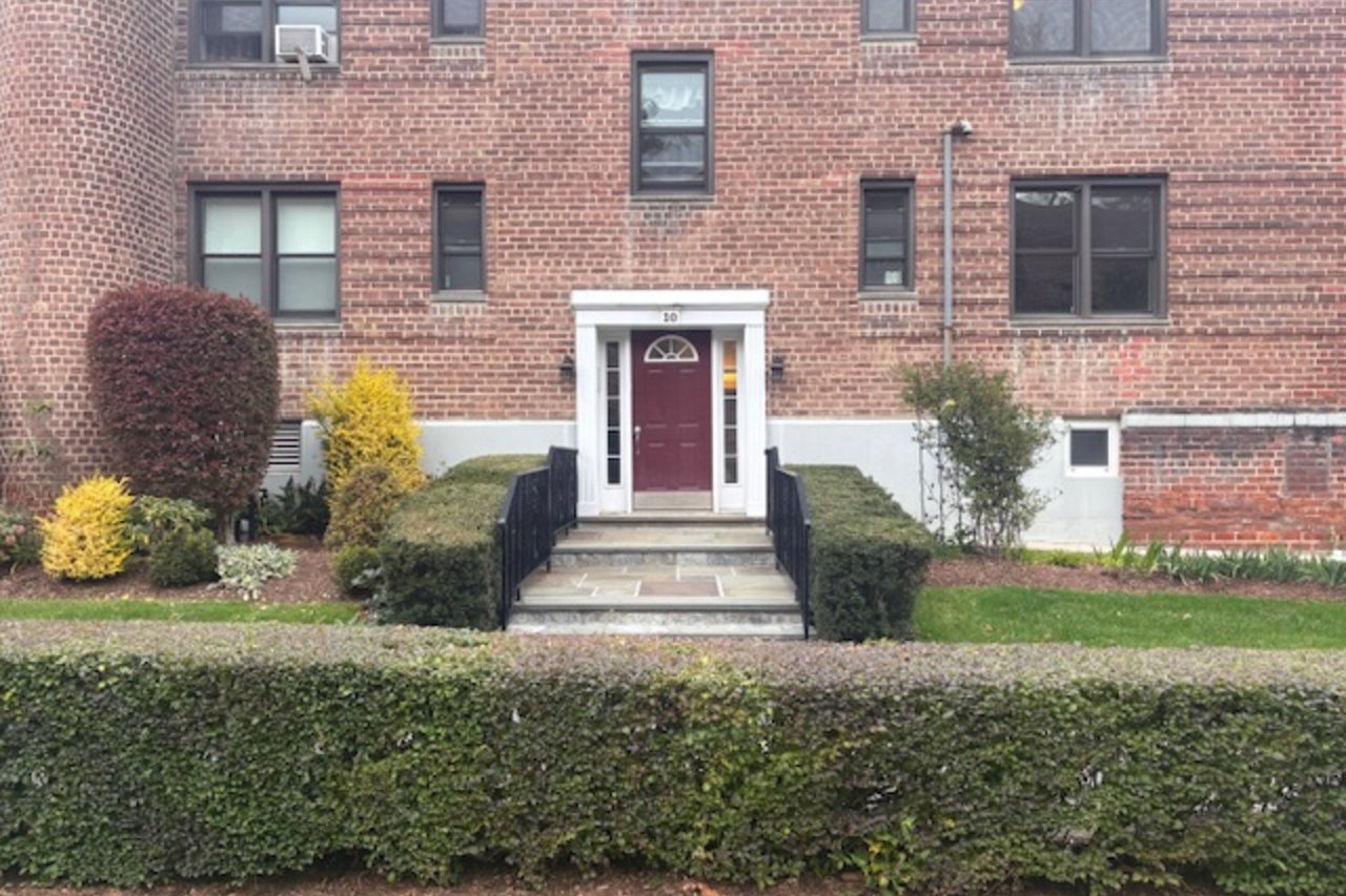 View of exterior entry featuring brick siding