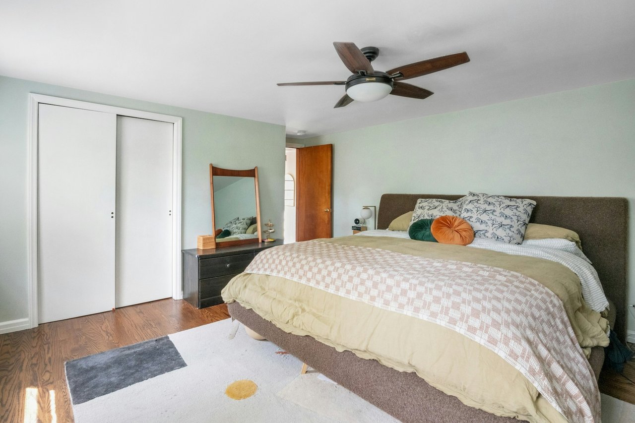 Bedroom featuring wood finished floors, a closet, and ceiling fan