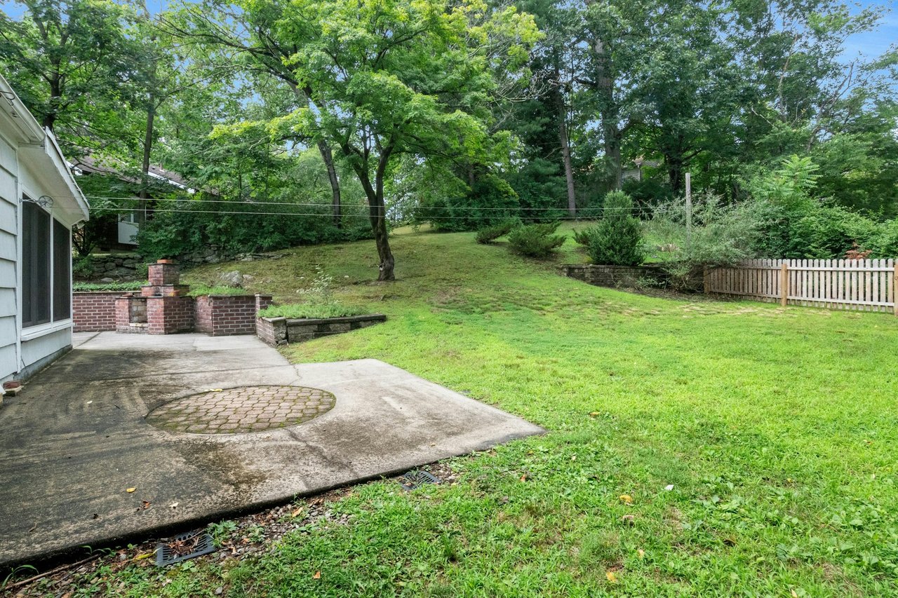 View of yard featuring a patio area and view of scattered trees