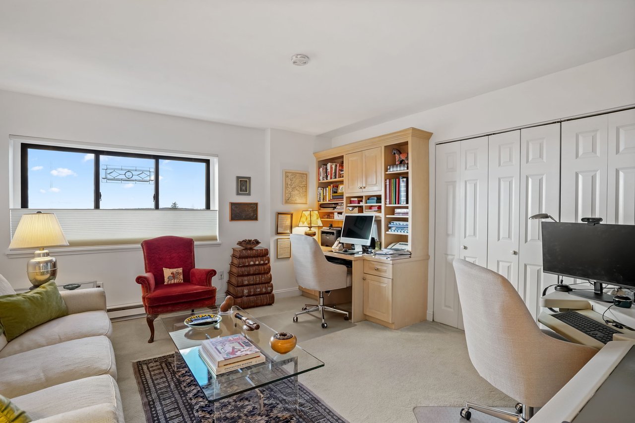 Second bedroom currently being used as a den features wall to wall carpet, great views and built-in desk with bookshelves.