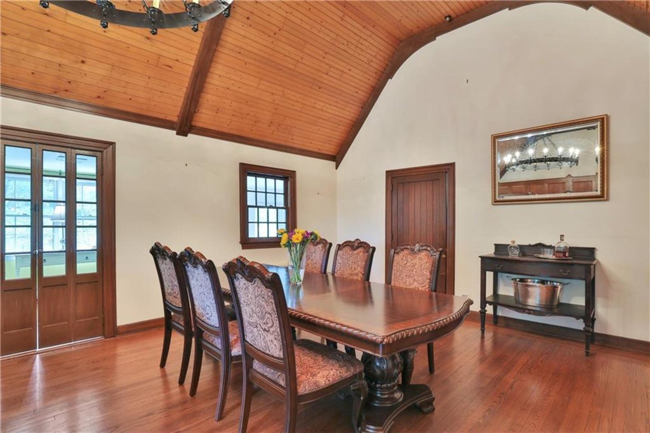Pic of Former Dining space featuring wood finished floors, a wooden ceiling with exposed beams, and high vaulted ceiling