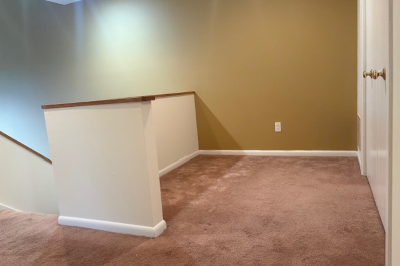 Empty room featuring light carpet