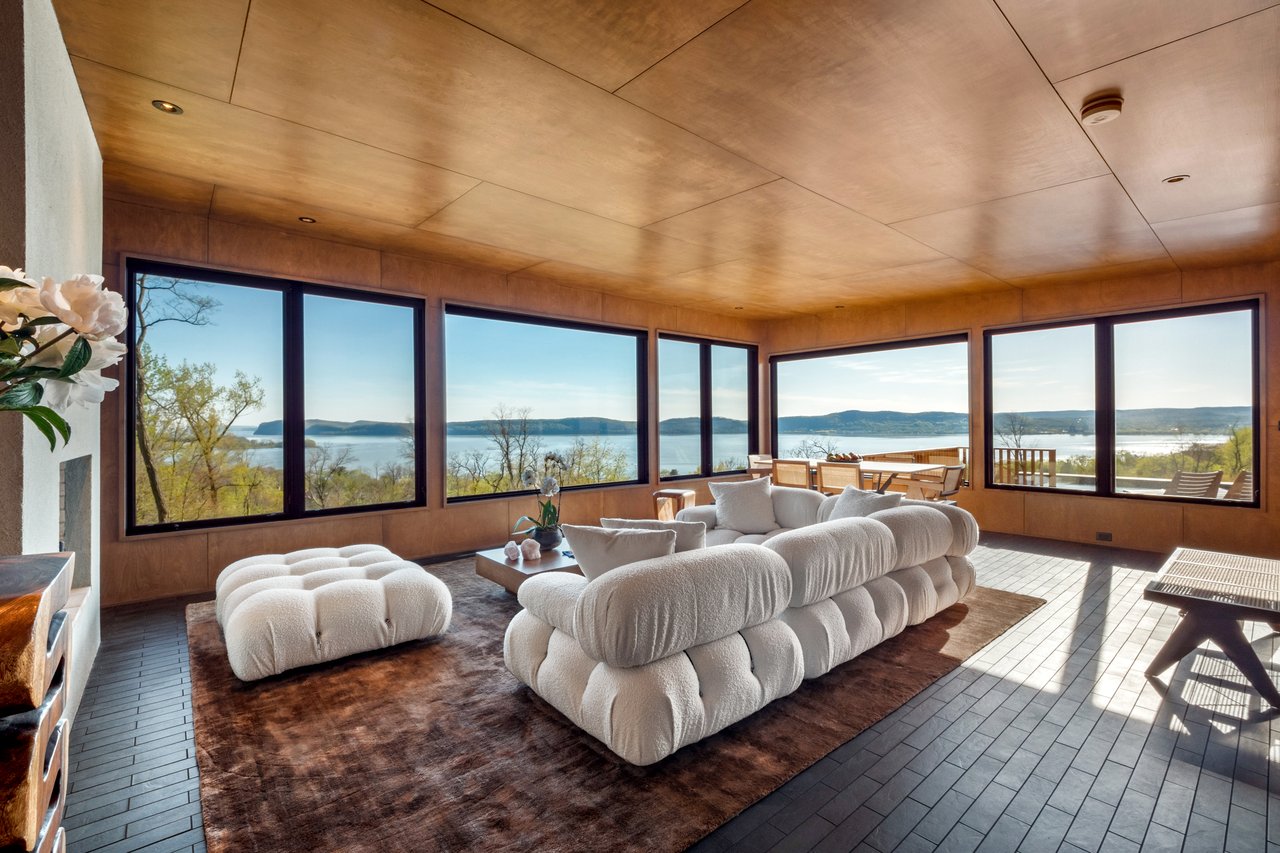 Sunroom featuring a water and mountain view