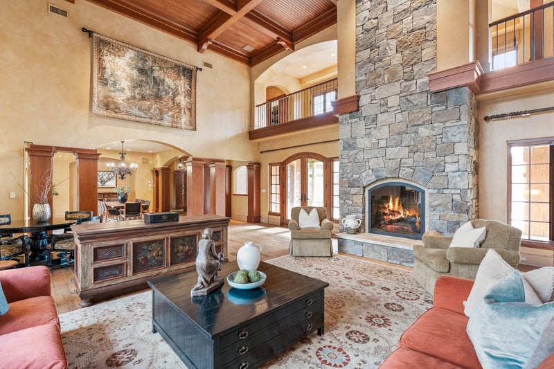 Spectacular two story great room with floor to ceiling stone fireplace provides a warm and inviting ambiance