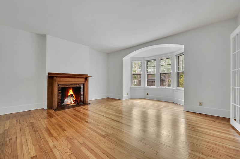 Living room with arched windows area and decorative fireplace