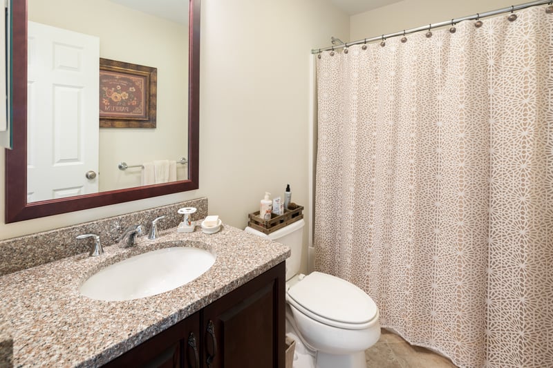 Hall Bathroom with granite vanity.	
