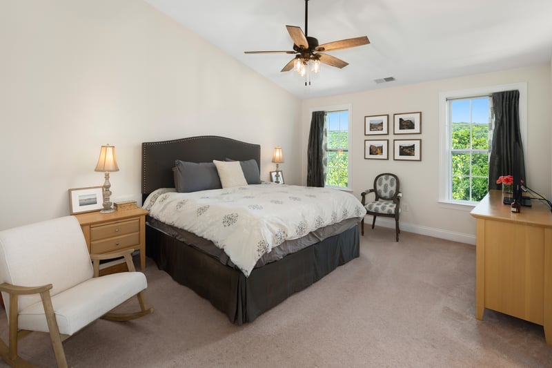 The primary suite has stunning tranquil views and a lofty vaulted ceiling.	