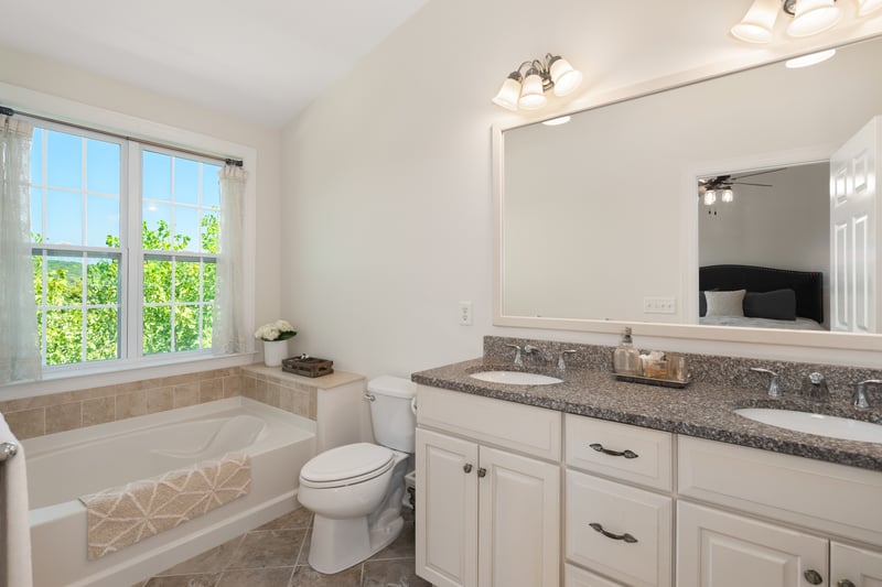 Primary bathroom ensuite spa with tranquil views of rolling hills.
