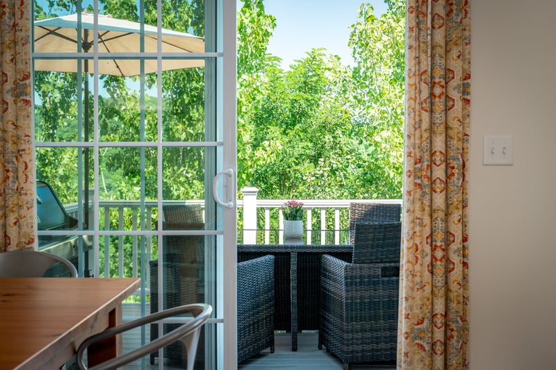 Sliders in kitchen lead to an outdoor deck for grilling	