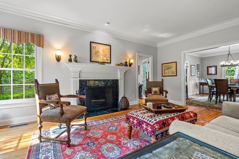 Elegant formal living room with fireplace that leads to the dining room.
