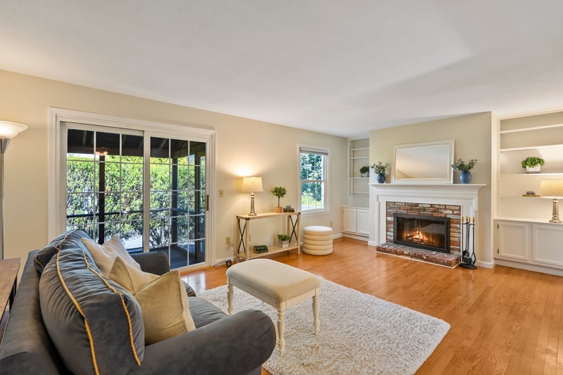 Built-in book shelves and wood burning fireplace in generous sized living room