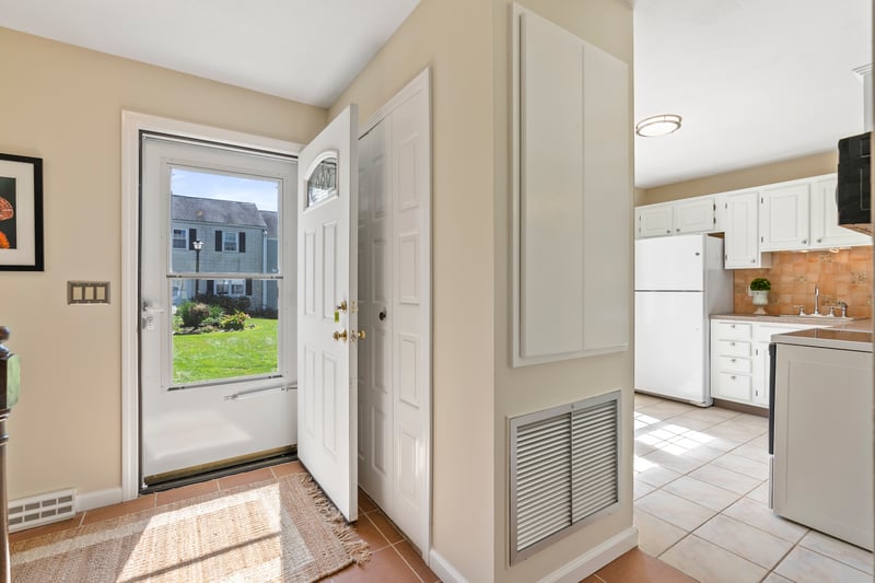Entrance foyer opens to kitchen and hallway to living room