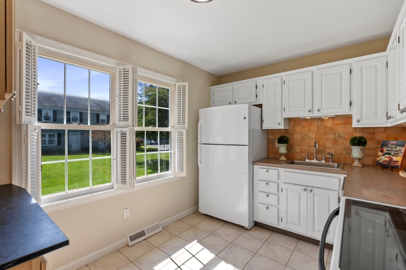 Sunny kitchen with pretty white cabinetry