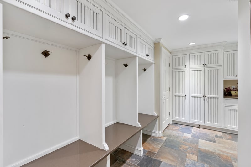 Laundry entrance with built-ins and stone floor
