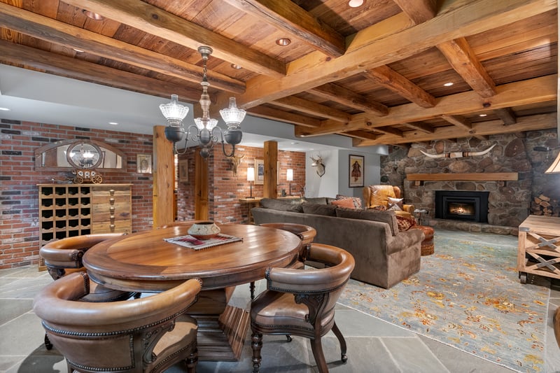 Rustic elegance in this spacious post and beam game room in lower level with warm, inviting fireplace