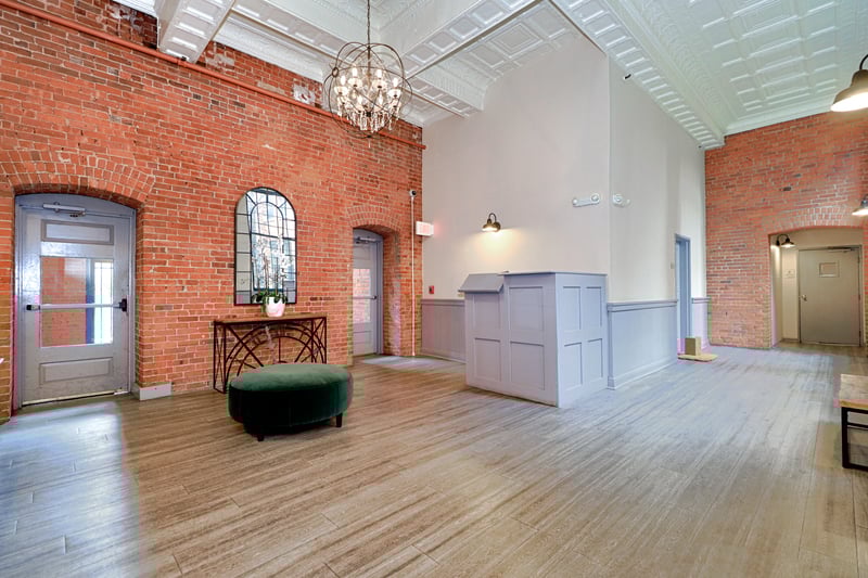 Lobby, note the high ceilings and exposed brick.