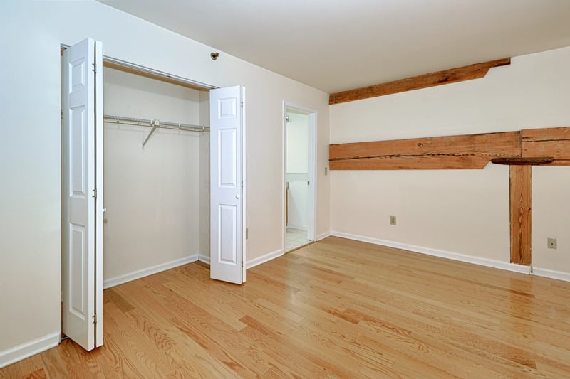 Closet and bath doors open to see location. Most put their bed against the wall with the beams, as it acts as a shelf.