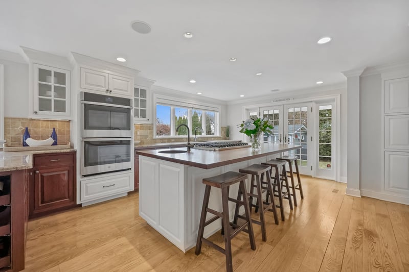Pretty combination of white cabinetry and wood.