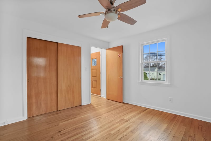 Bedroom with hardwood floors and ample closet space