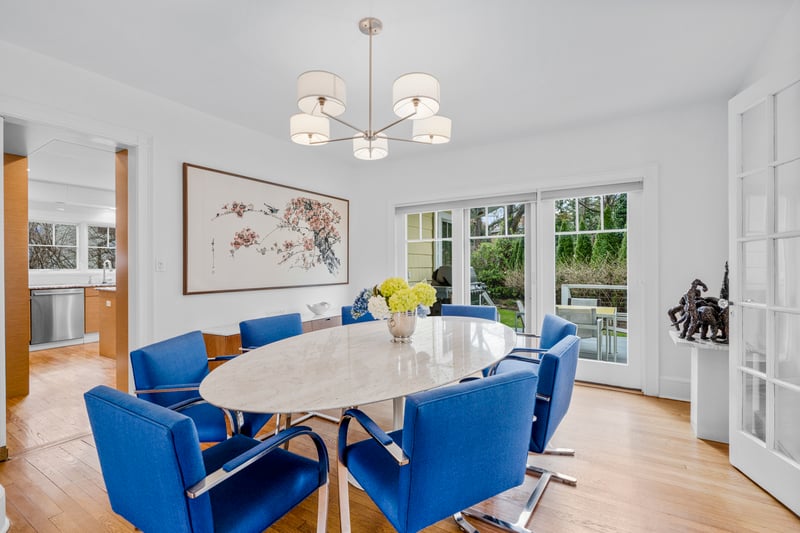 Dining area with light wood-type flooring and an inviting chandelier