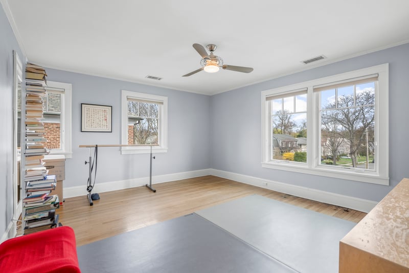 Workout area with ceiling fan, wood finished floors, and visible vents