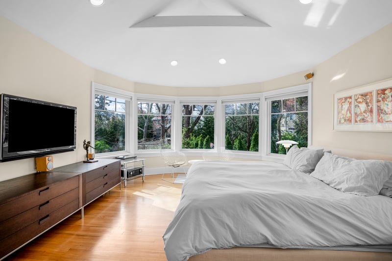 Bedroom with multiple windows, light wood finished floors, and recessed lighting