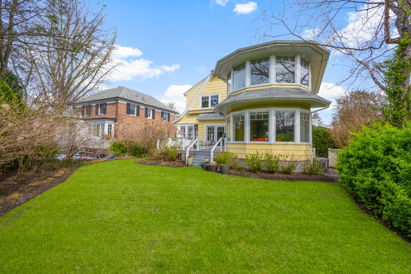 Rear view of property with a lawn