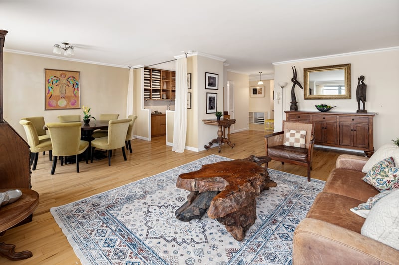 Living area with baseboards, wood finished floors, and crown molding