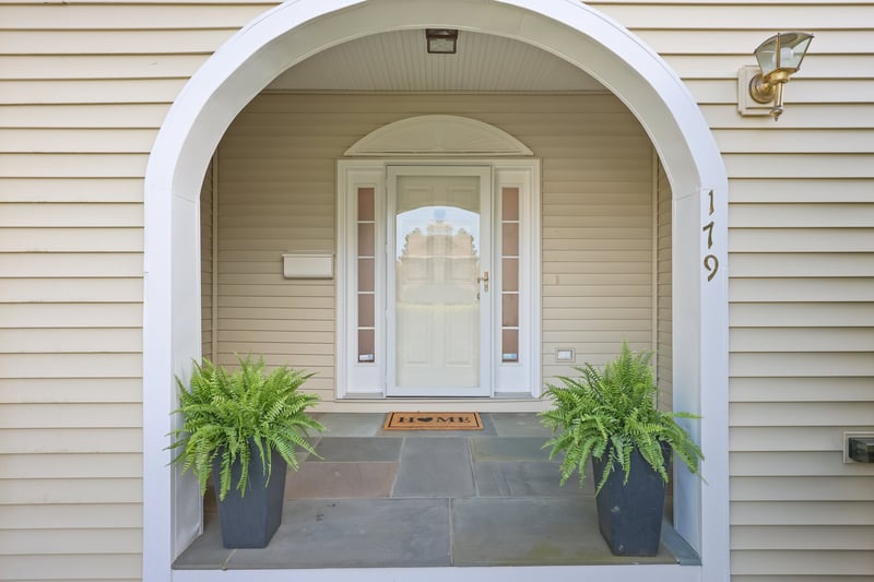 A lovely front porch with bluestone welcomes guests!