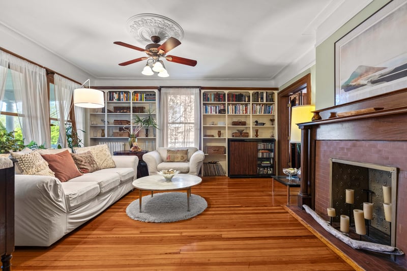 Living room with natural light, built ins, and a decorative fireplace (non working)