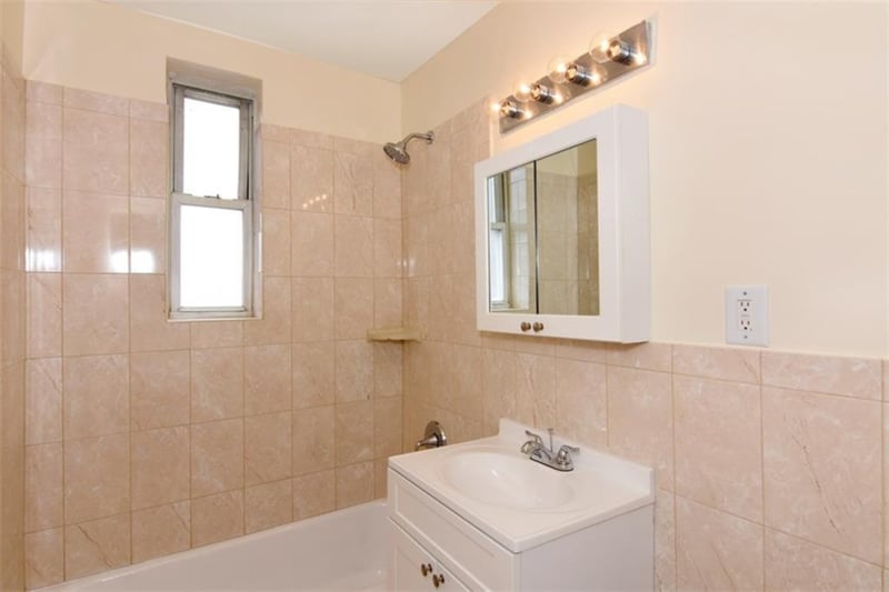 Simple bath with a tub, shower and vanity.